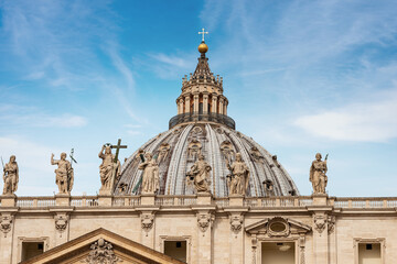 Closeup of the famous Basilica of Saint Peter with de dome, the marble statues of Jesus Christ, of St. John the Baptist and te apostles. Vatican city. Rome, Lazio, Europe.