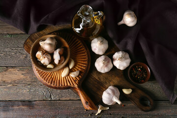 Bowl with fresh garlic on wooden table