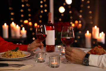 Couple having romantic dinner in restaurant, closeup