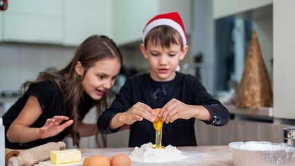 Siblings are cooking on the kitchen
