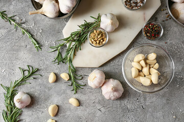 Fresh garlic with herbs and spices on grey table