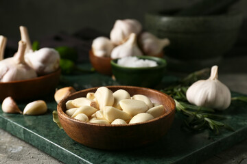 Bowl with fresh garlic on table