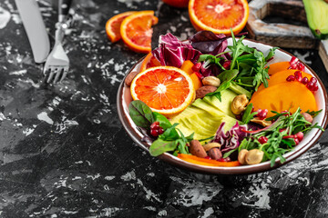 Fototapeta na wymiar Vegetarian salad. Clean healthy eating concept. Buddha bowl with avocado, blood orange, broccoli, watermelon radish, spinach, quinoa, pumpkin seeds. space for text. top view