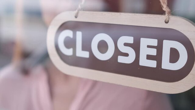Small business closing up. Turning the sign from open to closed. 4k 60fps