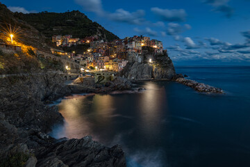 Manarola village at sunset on Mediterranean sea in National park Cinque Terre, La Spezia, Liguria, Italya