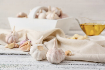 Fresh garlic on light wooden background