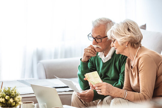  Senior Couple Having Problems With Home Finances. Senior Couple Looking Stressed While Going Over Their Finances At Home