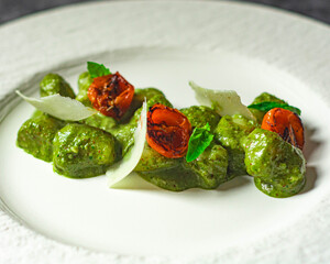 Delicious gnocchi with pesto , cherry tomatoes and parmesan shavings. Simple dish revisited witha  gourmet twist