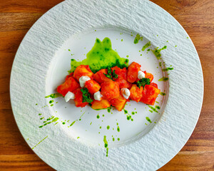 Gnocchi all'arrabbiata, with tomato sauce and parsely pesto. Vegan dish