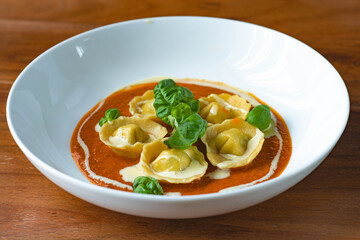 Handmade Tortelli with tomato sauce , basil and parmesan shavings. Revisited dish of Melanzane alla Parmigiana ( eggplant parmigiana)