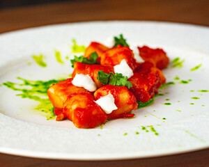 Gnocchi all'arrabbiata, with tomato sauce and parsely pesto. Vegan dish