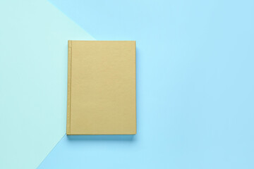 Blank book on color background