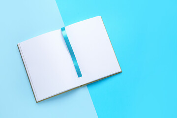 Blank book with bookmark on color background