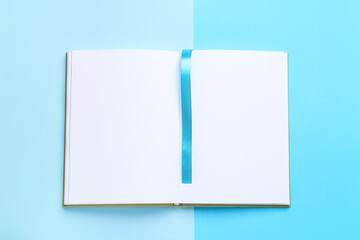 Blank book with bookmark on color background
