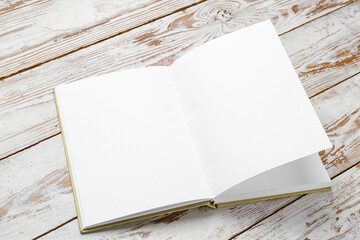 Blank open book on wooden background