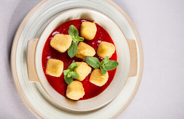portion of fresh made fried camembert cheese served with berry jam