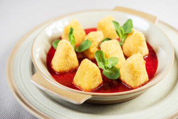 portion of fresh made fried camembert cheese served with berry jam
