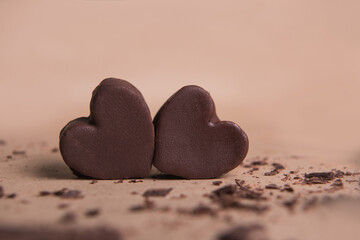 Two handmade chocolate hearts on craft background with crisps. Valentine s concept, copy space