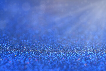 Blue background, abstract bokeh with sun rays.