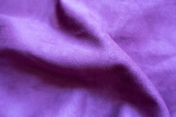 Close shot of draped violet faux suede fabric