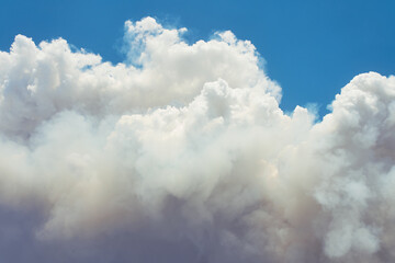Dense white smoke rising from the raging wildfire,