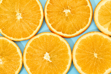ripe slice orange fruit on blue background. top view