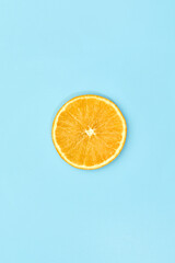 ripe slice orange fruit on blue background. top view