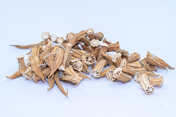 Dried okras on a white background. Dry okras on string.
