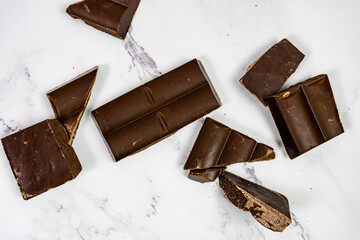 quality chocolate on white marble bottom tablet into pieces
