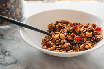 Bowl of muesli with berries. Granola with dry cherries