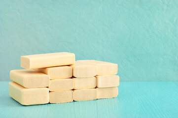 A lot of solid soap in a heap. Solid soap and space for text. Lots of solid soap for hygiene and cleanliness.