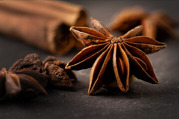 star anise on a dark background along with vanilla