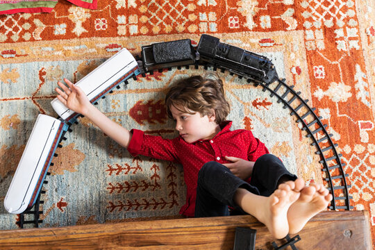 overhead view of young boy playing with his train