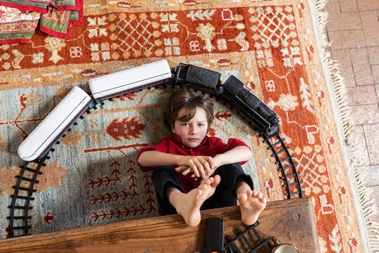 overhead view of young boy playing with his train