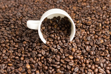 Aromatic coffee beans in a mug.