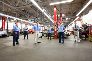 Portrait of Six Mechanics in Auto Repair Shop viewed from above
