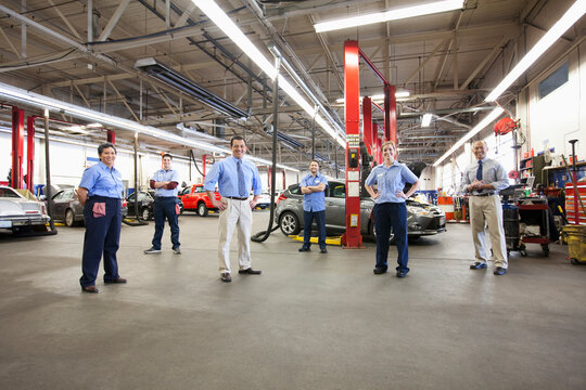 Portrait of Six Mechanics in Auto Repair Shop viewed from above