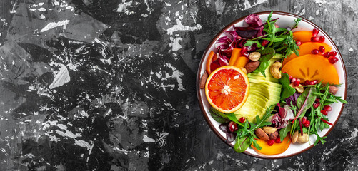 Healthy food concept. Vegan salad with avocado, blood orange, broccoli, watermelon radish, spinach, quinoa, pumpkin seeds. Long banner format, top view