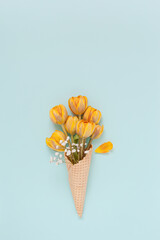 Ice cream cone with tulip flowers. Flat lay, copy space