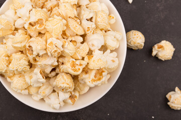 Heap of delicious salty popcorn, isolated on black background.