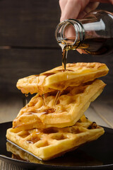 Vienna waffles with maple syrup close-up.