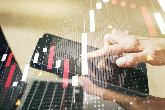 Multi exposure of abstract financial graph with world map and hand working with a digital tablet on background, financial and trading concept