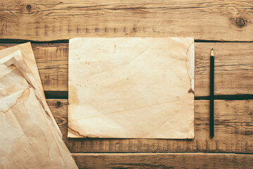 Old vintage note paper on a wooden table. Copy space