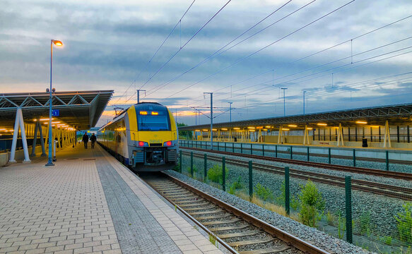 Brecht, Belgium - June 2019: A commuter train of there Belgian Railways (NMBS/SNCB) in the Noorderkempen railway station in Brecht heading to the Antwerp Central railway station at the break of dawn