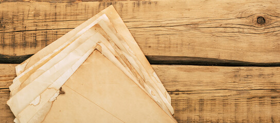 Old vintage note paper on a wooden table. Copy space