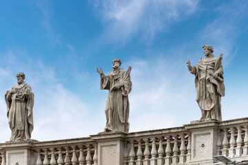 Closeup of the famous colonnade with statues by Giovanni Lorenzo Bernini in Saint Peter square, Vatican city. Rome, Lazio, Europe.