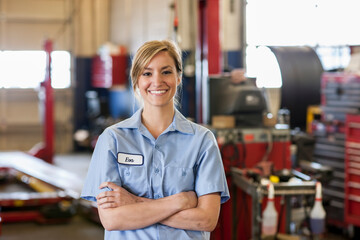 Portrait of young female Caucasian mechanic in auto repair shop