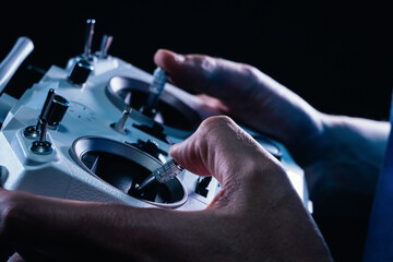 side view of a boy flying a drone