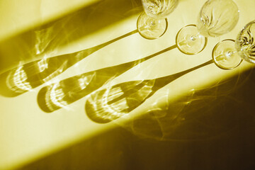 Empty glasses stand on a yellow background, top view.