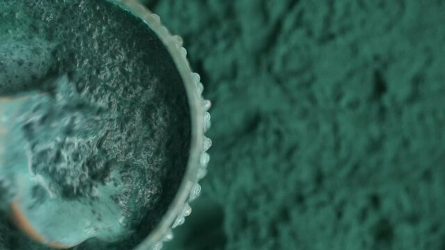 glass of milk with spirulina powder view from top
